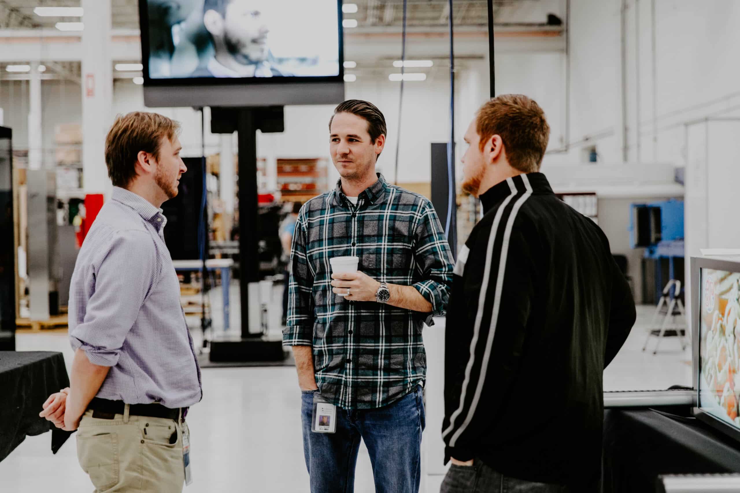 Three male coworkers talking