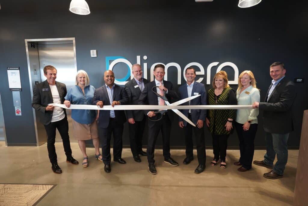 People cutting a ribbon in front of a business
